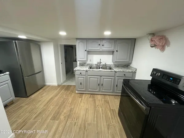a kitchen with granite countertop a sink and cabinets