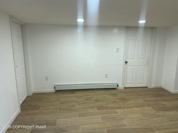 a view of hallway with wooden floor