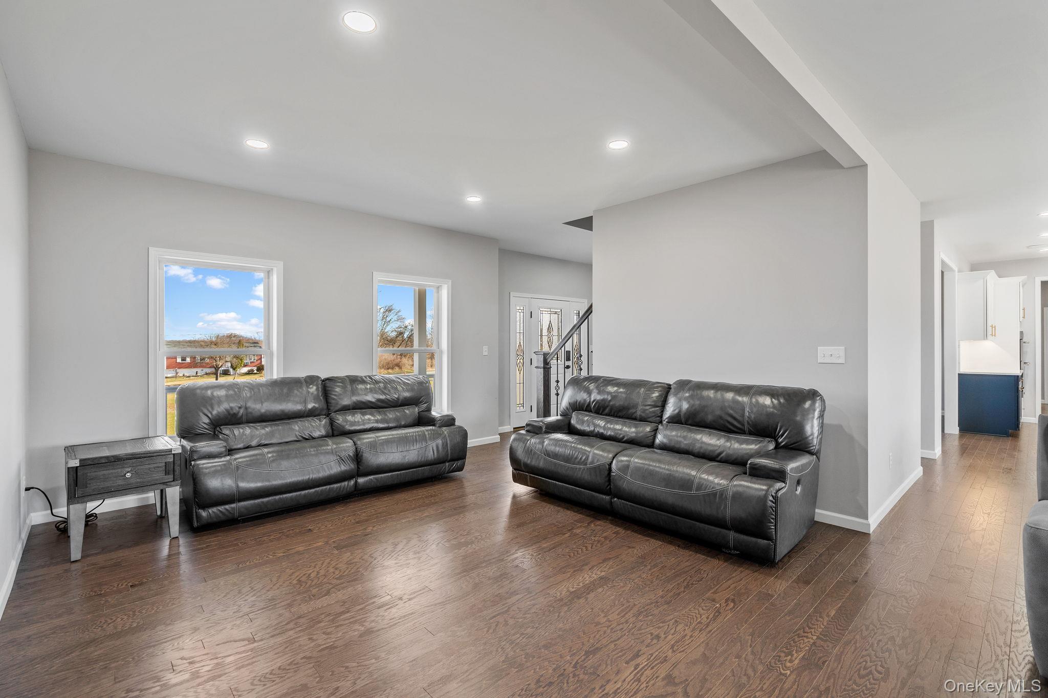 10 Harrier Ridge Drive Wallkill, NY 12589 - Photo 13 of 46 Living room featuring dark wood-style floors, recessed lighting, and stairway