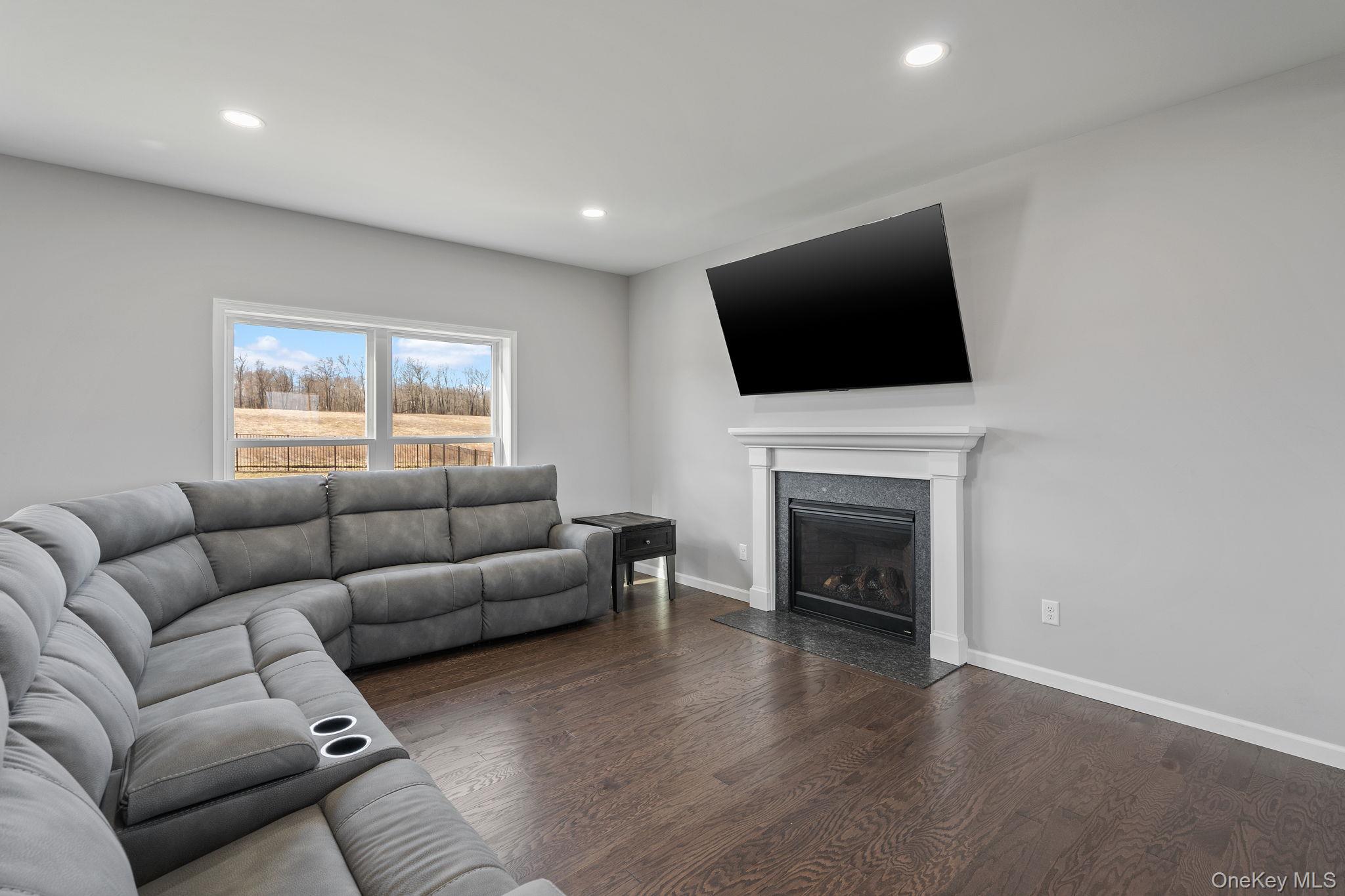 10 Harrier Ridge Drive Wallkill, NY 12589 - Photo 16 of 46 Living area with a fireplace, dark wood-style flooring, and recessed lighting