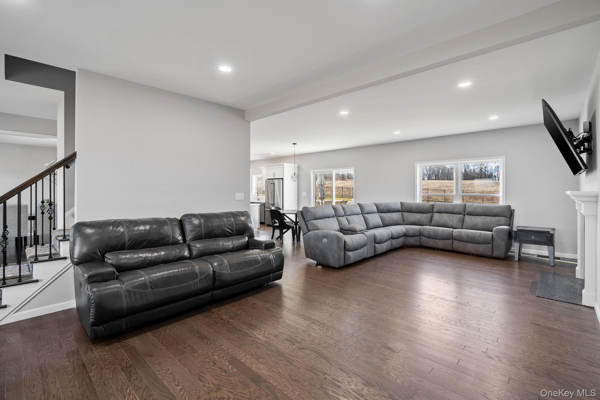 10 Harrier Ridge Drive Wallkill, NY 12589 - Photo 18 of 46 Living room with dark wood-type flooring, stairway, and recessed lighting