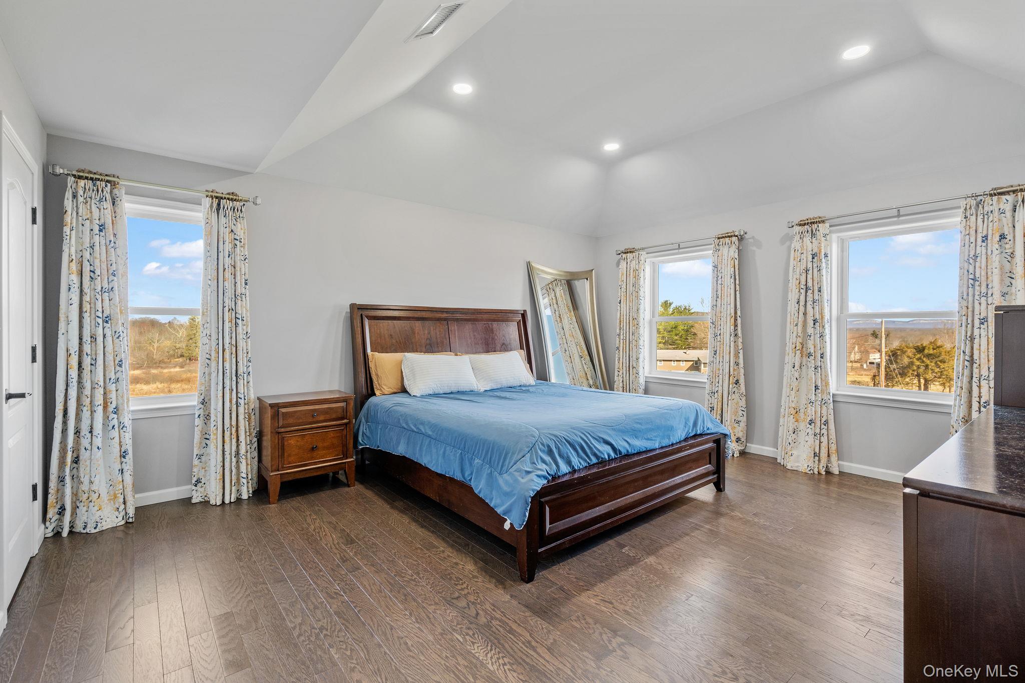 10 Harrier Ridge Drive Wallkill, NY 12589 - Photo 23 of 46 Bedroom with dark wood finished floors, vaulted ceiling, multiple windows, and recessed lighting