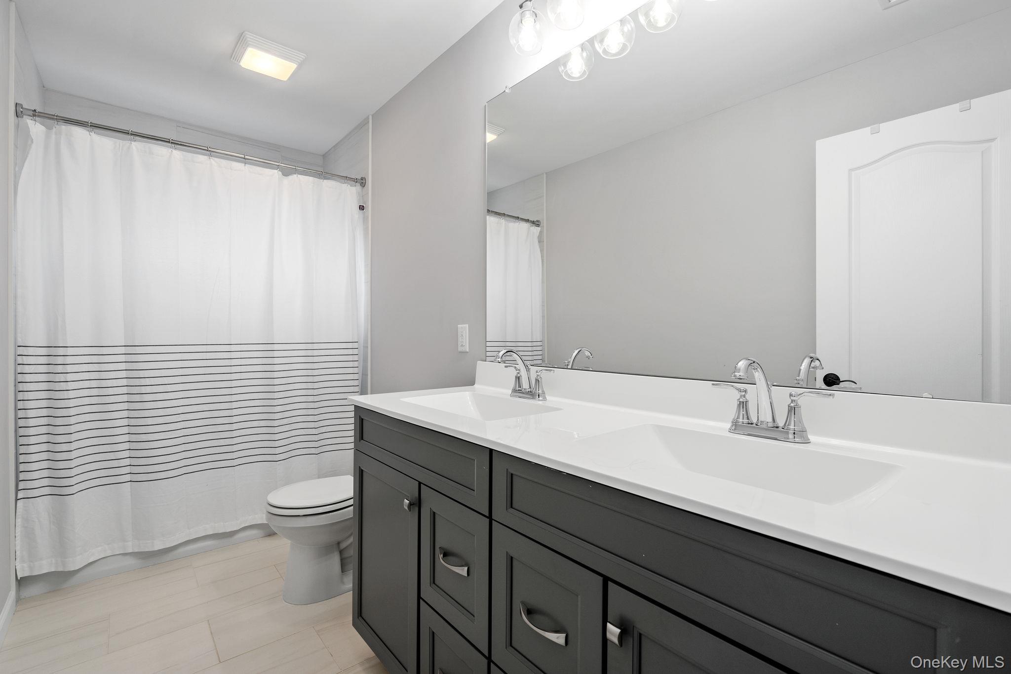 10 Harrier Ridge Drive Wallkill, NY 12589 - Photo 29 of 46 Full bathroom featuring double vanity and a shower with shower curtain