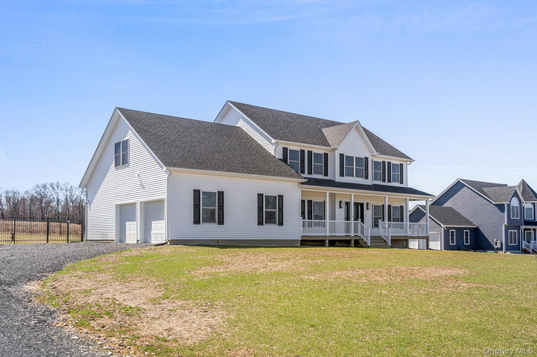 10 Harrier Ridge Drive Wallkill, NY 12589 - Photo 39 of 46 View of front of home with a porch, a front yard, driveway, roof with shingles, and an attached garage
