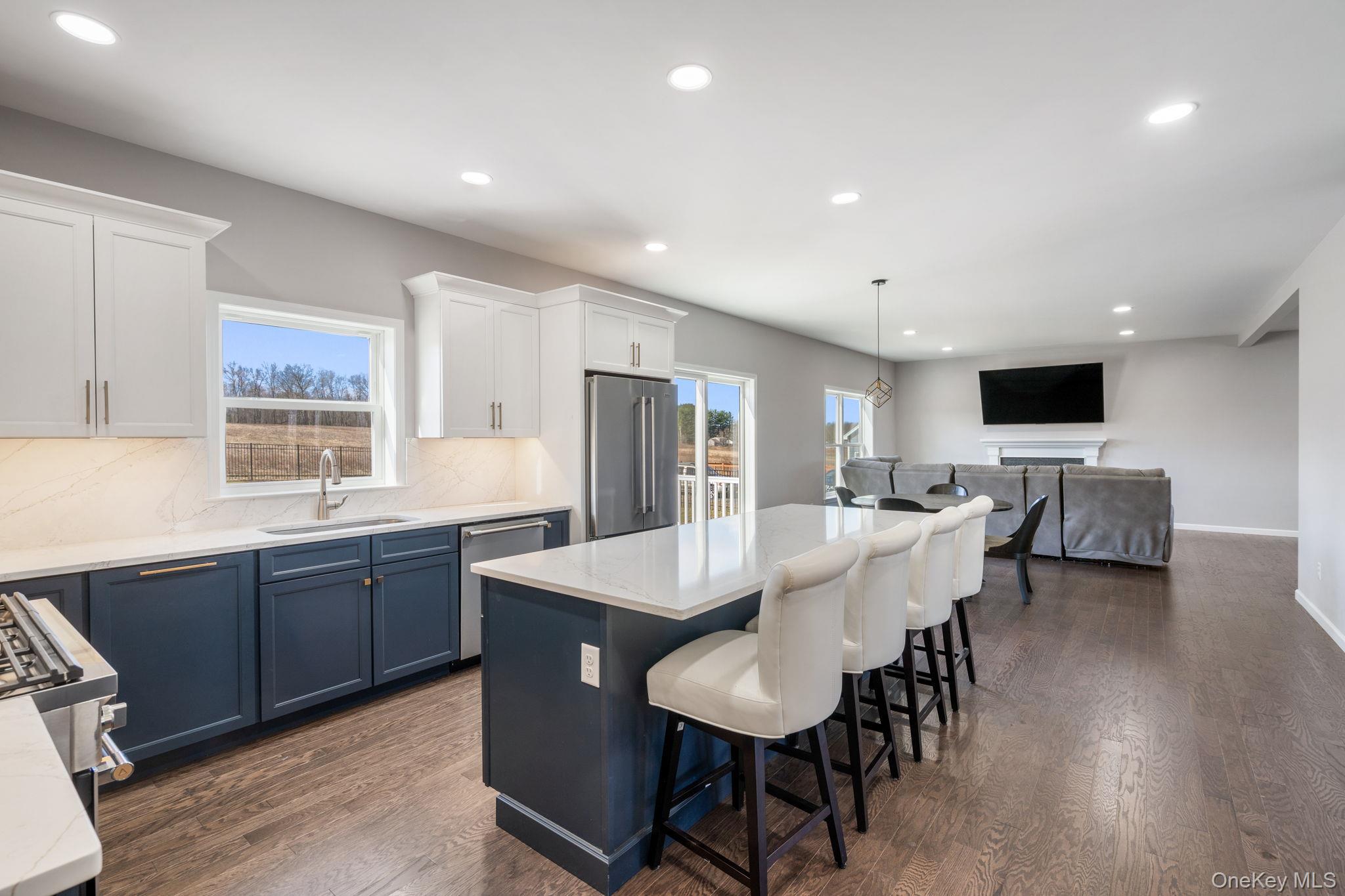 10 Harrier Ridge Drive Wallkill, NY 12589 - Photo 46 of 46 Kitchen featuring blue cabinets, recessed lighting, decorative light fixtures, open floor plan, and tasteful backsplash