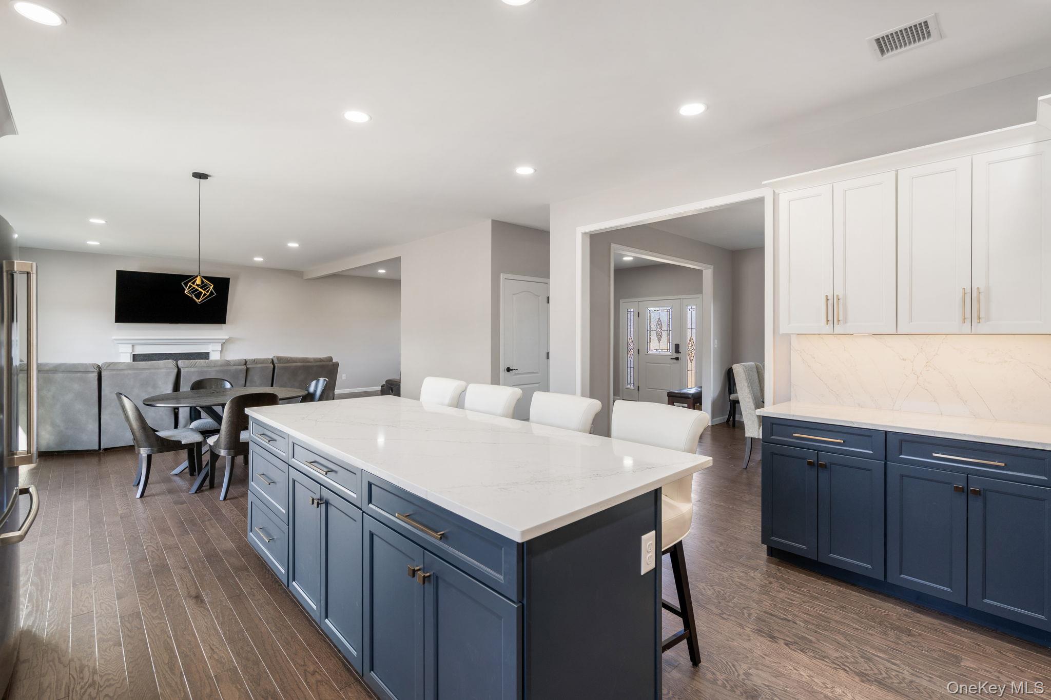10 Harrier Ridge Drive Wallkill, NY 12589 - Photo 4 of 46 Kitchen with blue cabinetry, a breakfast bar, light stone countertops, hanging light fixtures, and recessed lighting