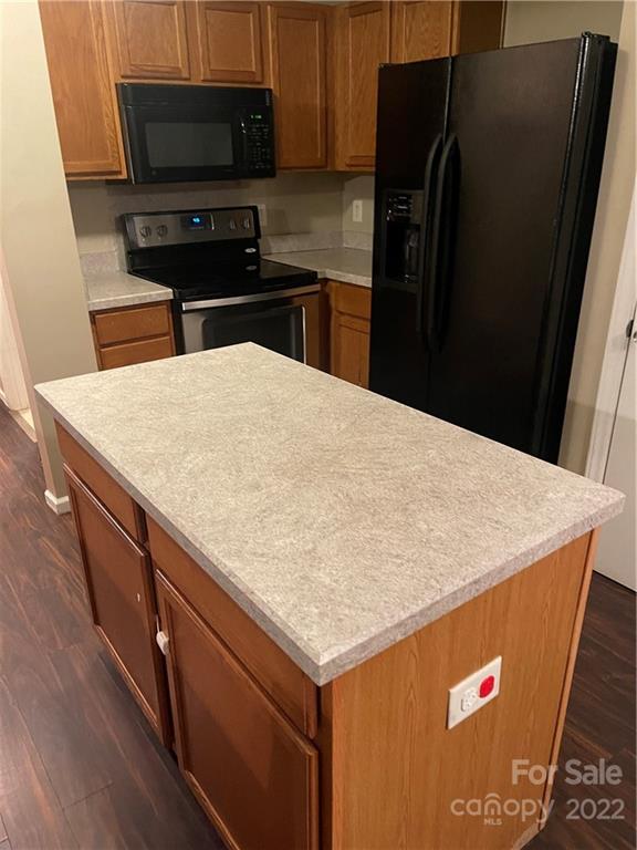 2005 Pimpernel Road Charlotte, NC 28213 - Photo 12 of 24 a kitchen with stainless steel appliances kitchen island a refrigerator sink and stove