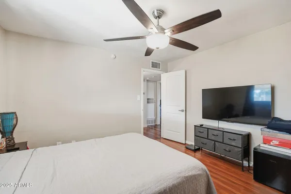a bedroom with a bed and a chandelier