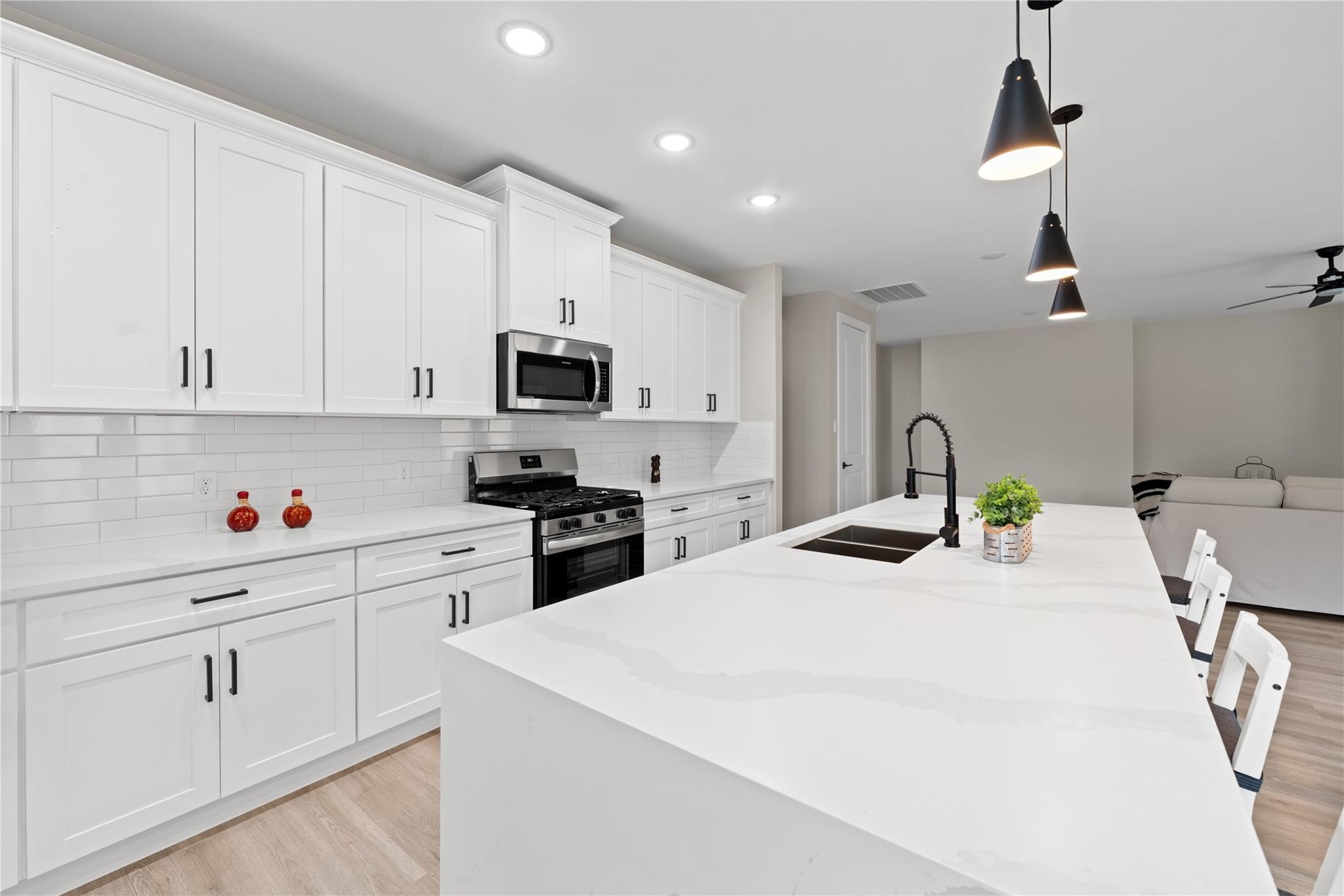 2606 Piemonte Avenue Cir Spring Spring, TX 77388 - Photo 5 of 14 a kitchen with stainless steel appliances kitchen island granite countertop a sink a stove and a refrigerator