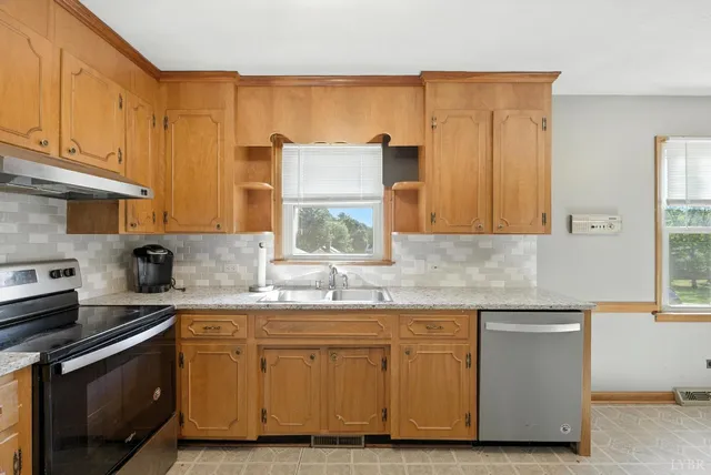 a kitchen with stainless steel appliances granite countertop a sink stove and cabinets