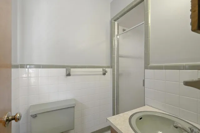 a large white kitchen with a stove a sink dishwasher and a refrigerator