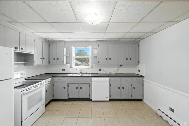 a kitchen that has a sink a refrigerator and window