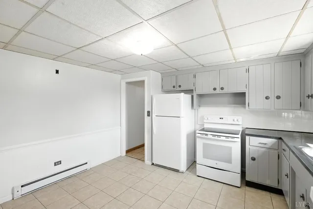 a view of an empty room with a fireplace and a window