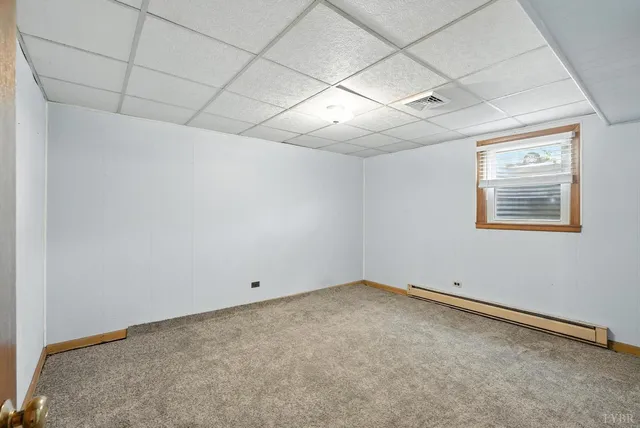 a view of a room with a wooden floor and entryway