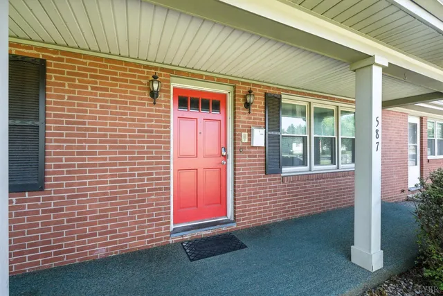 a front view of a house with a big yard