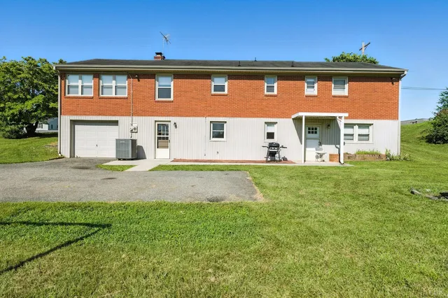 an aerial view of a residential house with a yard