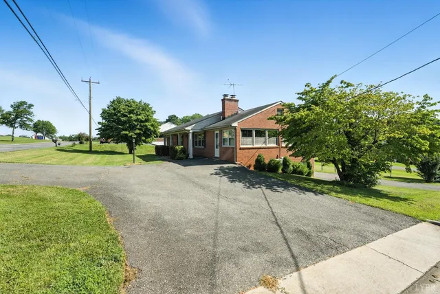 an aerial view of residential houses with outdoor space and street view