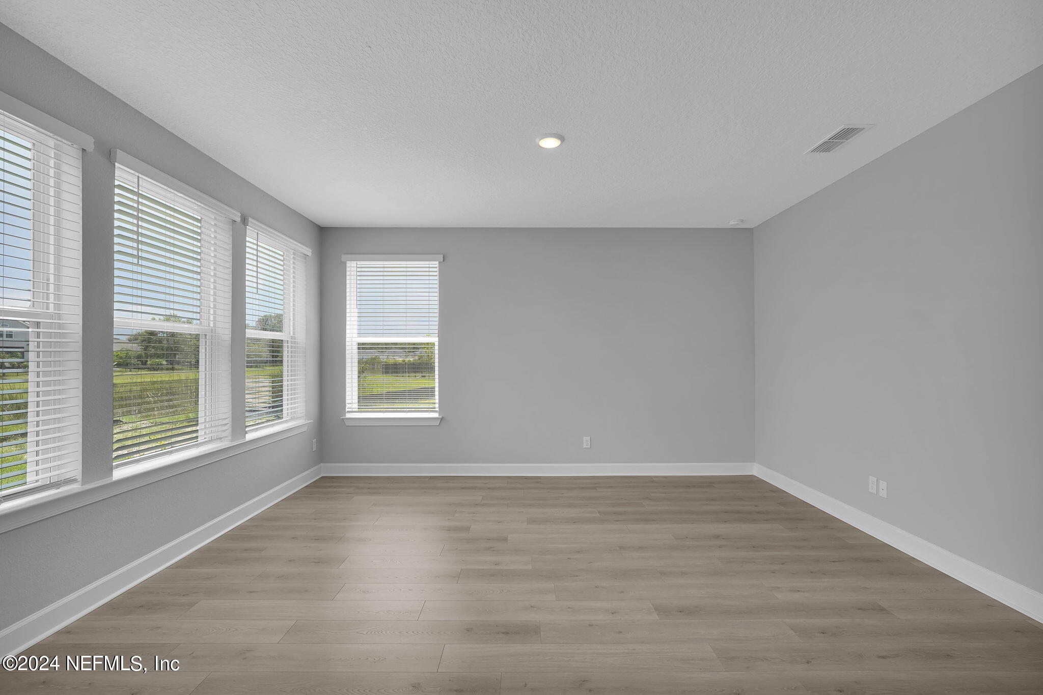 116 Greylock Lane St. Augustine, FL 32092 - Photo 17 of 50 a view of an empty room with wooden floor and a window