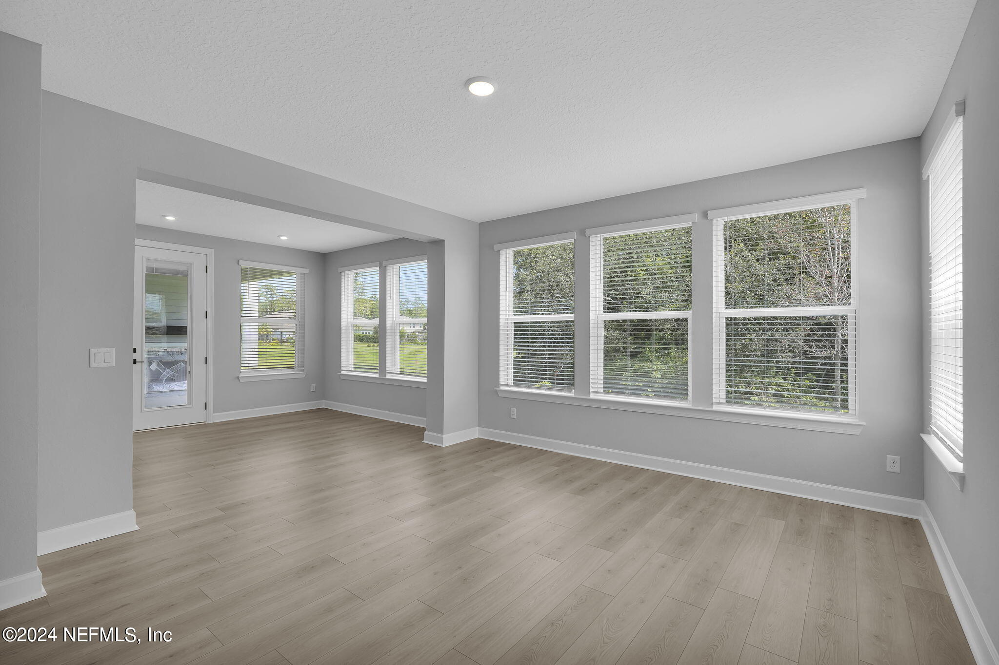 116 Greylock Lane St. Augustine, FL 32092 - Photo 18 of 50 an empty room with wooden floor and windows