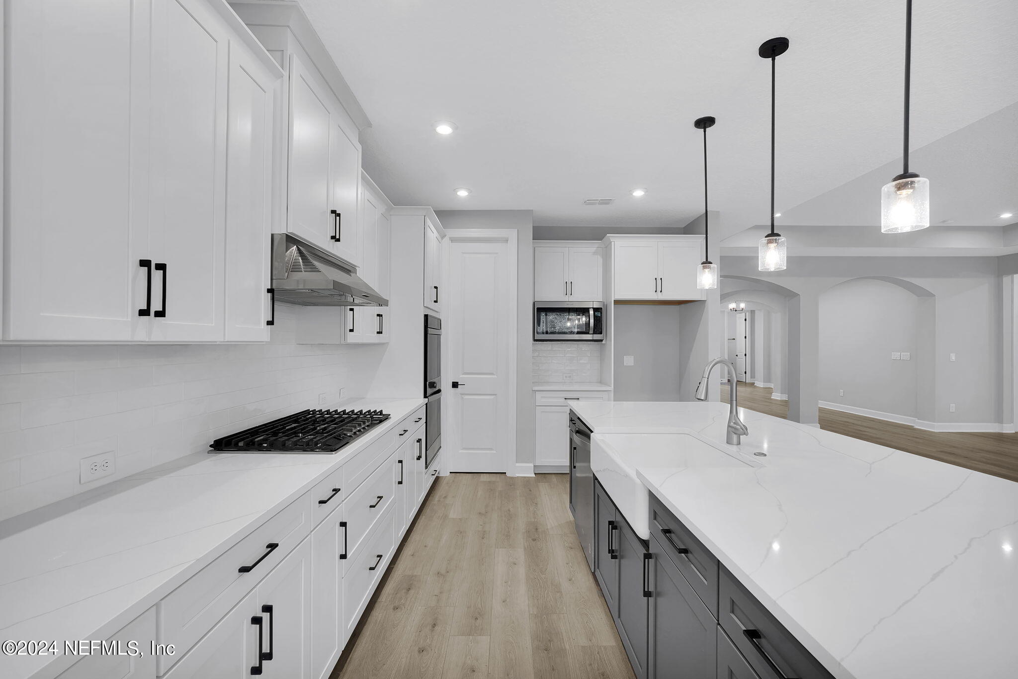 116 Greylock Lane St. Augustine, FL 32092 - Photo 27 of 50 a kitchen with kitchen island a sink stove and wooden floor