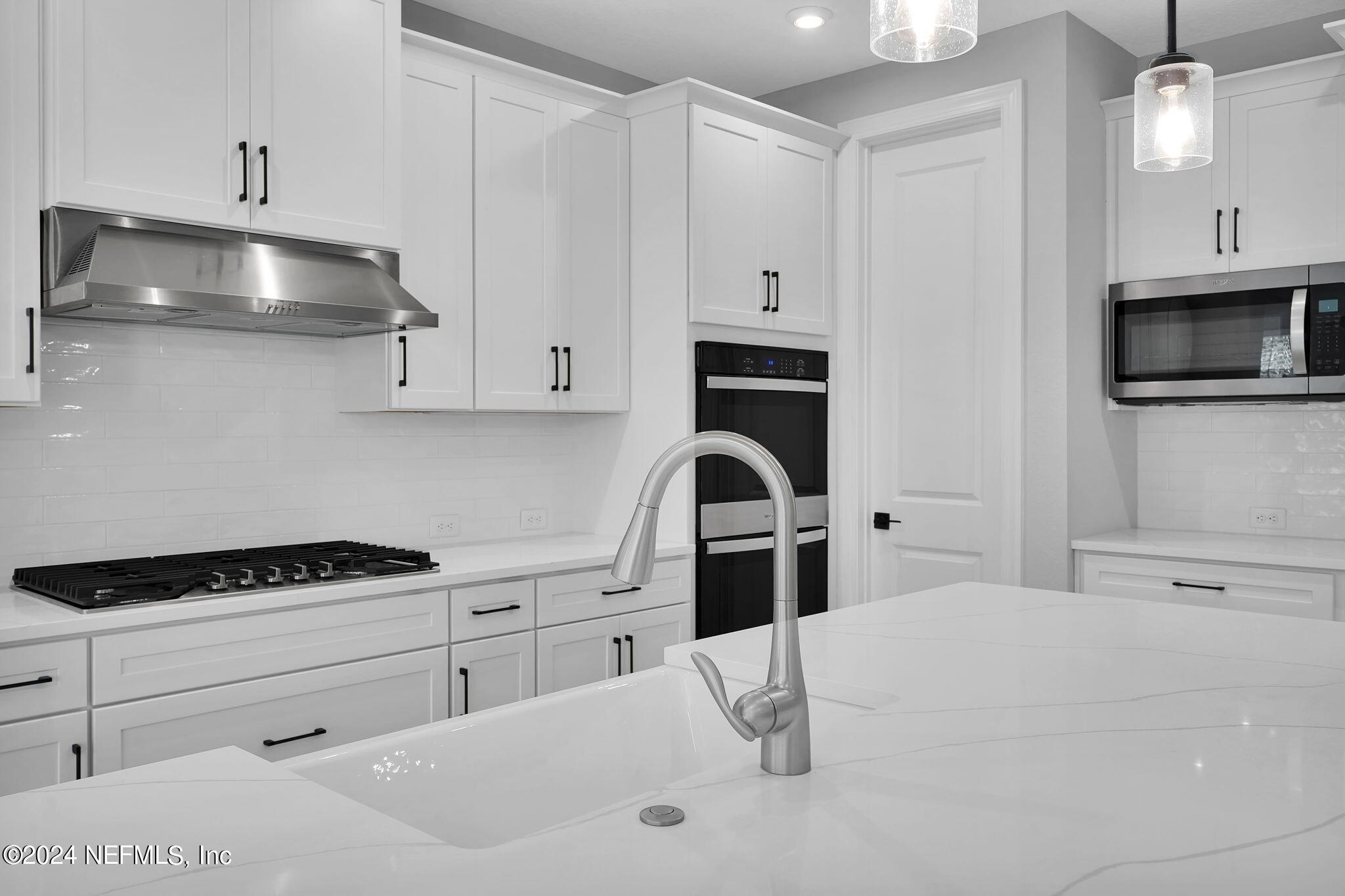 116 Greylock Lane St. Augustine, FL 32092 - Photo 29 of 50 a kitchen with granite countertop a sink a stove and cabinets