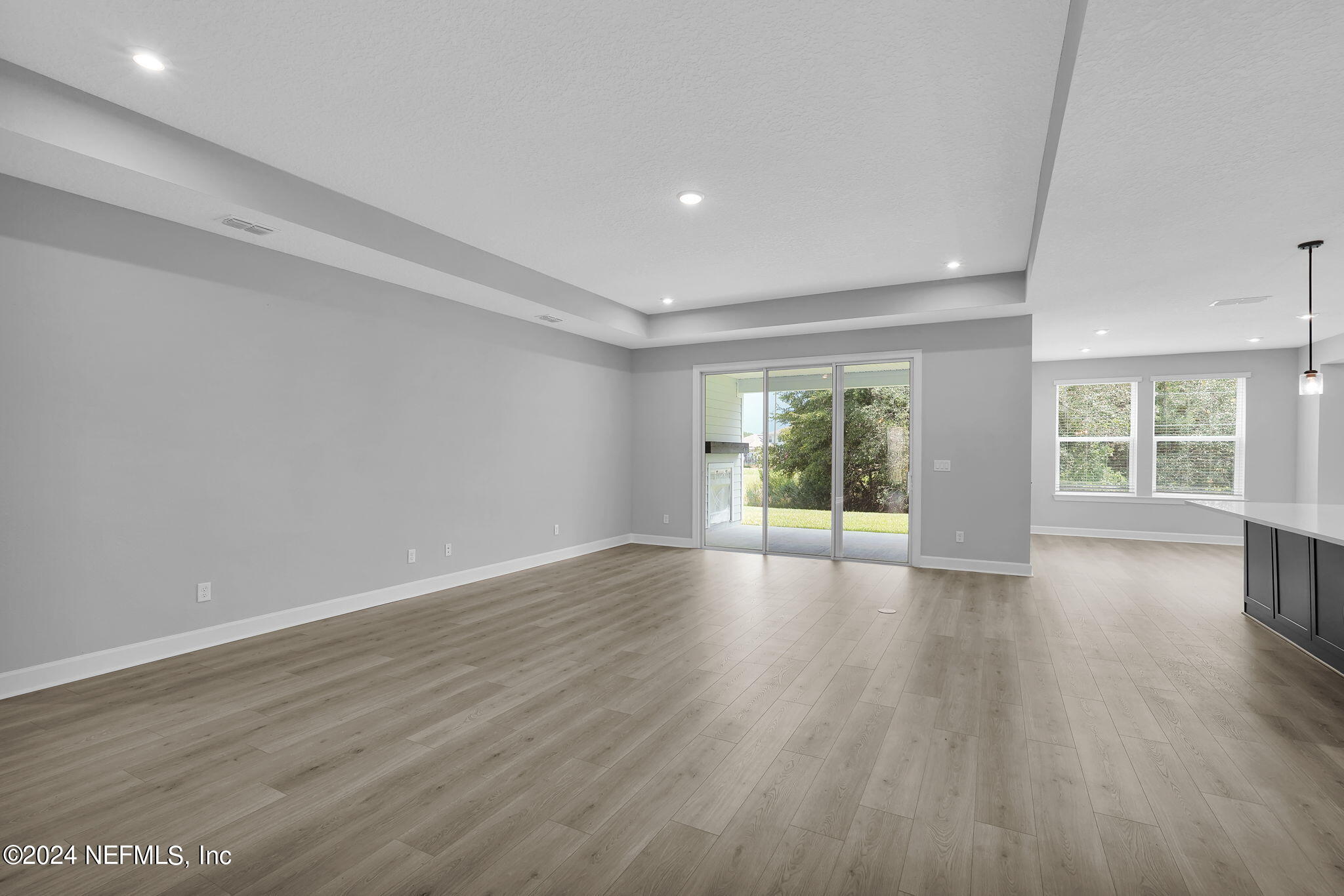 116 Greylock Lane St. Augustine, FL 32092 - Photo 33 of 50 a view of an empty room with wooden floor and a window