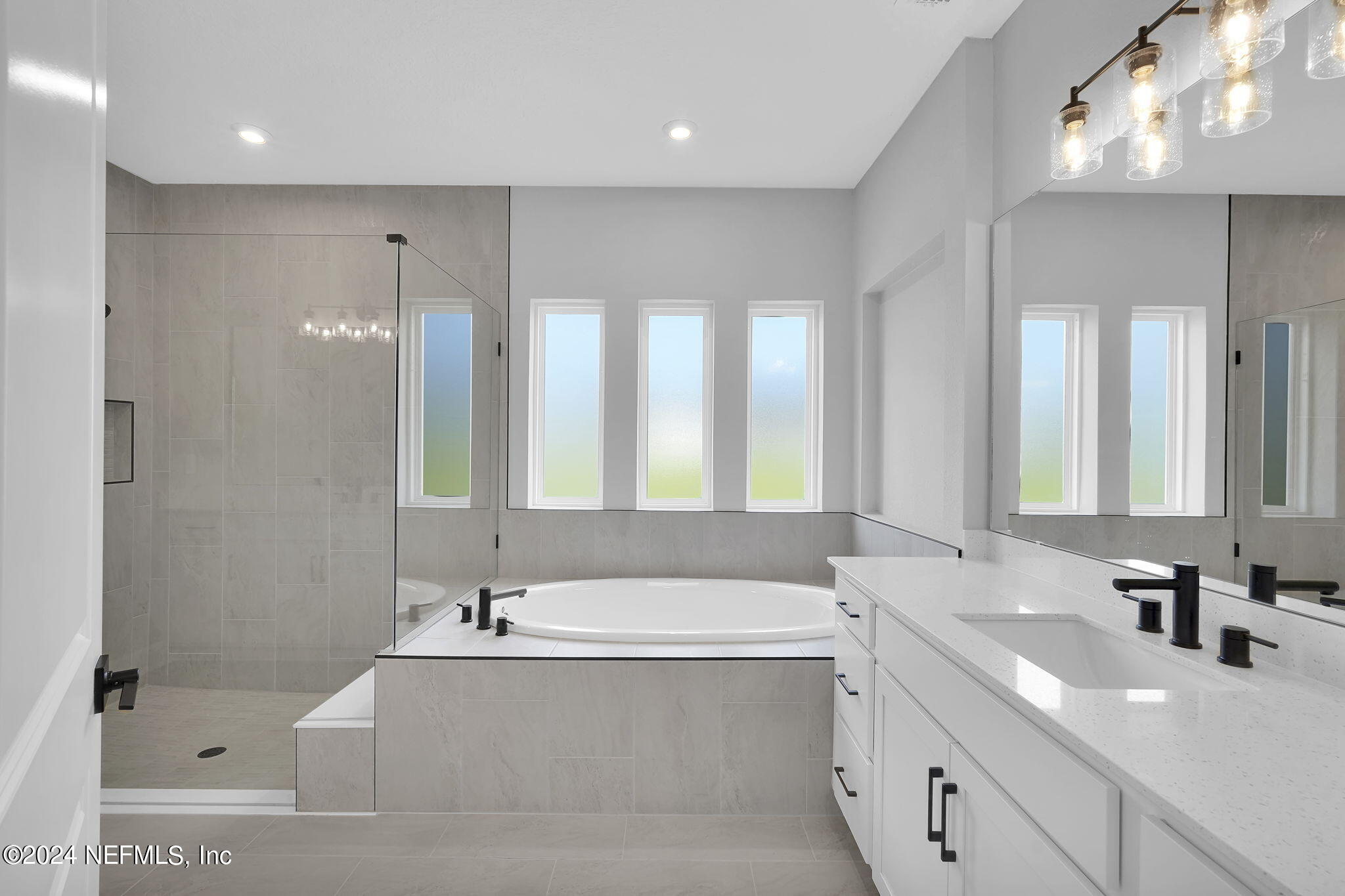 116 Greylock Lane St. Augustine, FL 32092 - Photo 38 of 50 a bathroom with a bathtub a double vanity sink and mirror