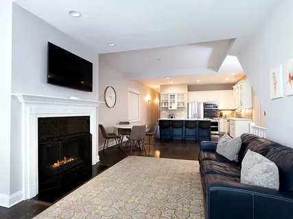 a living room with furniture a fireplace and a flat screen tv