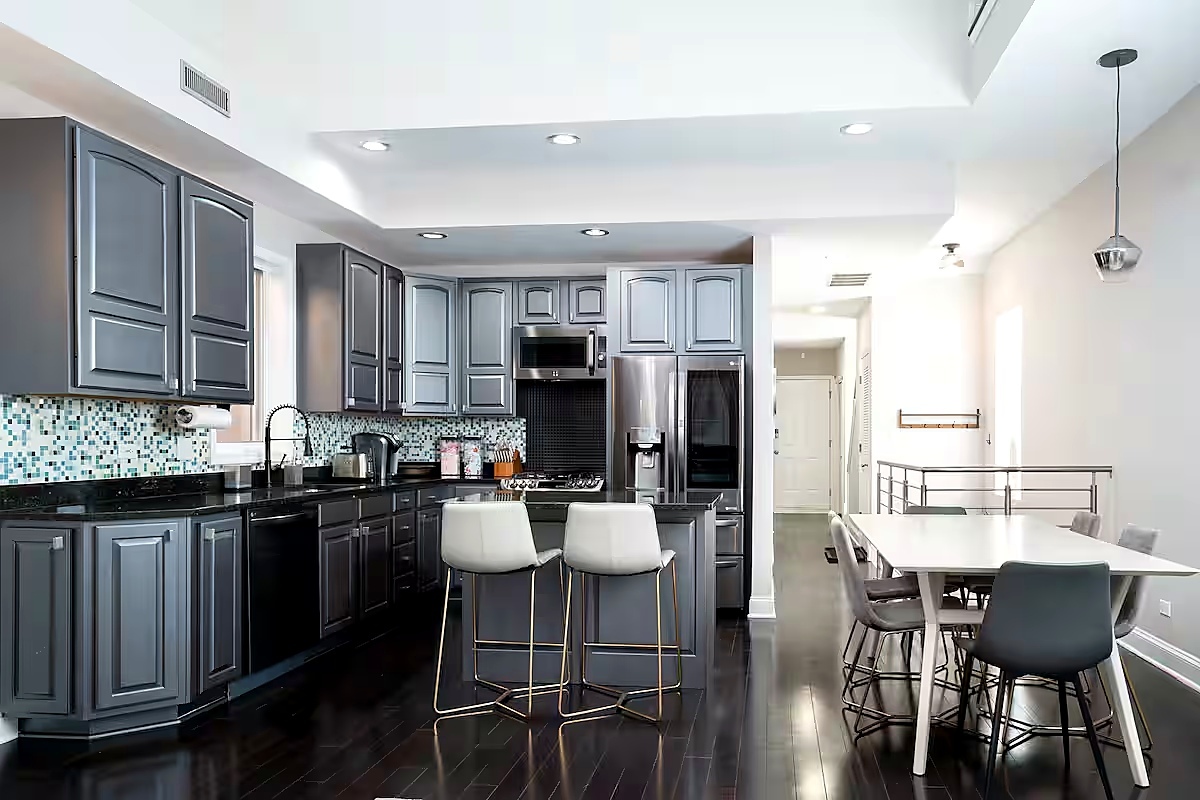 1427 North Mohawk Street Chicago, IL 60610 - Photo 24 of 54 a kitchen with a table chairs refrigerator and cabinets