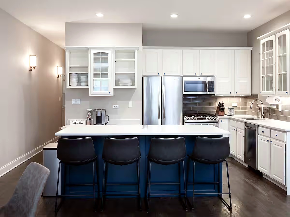 1427 North Mohawk Street Chicago, IL 60610 - Photo 3 of 54 a kitchen with stainless steel appliances a table chairs refrigerator and cabinets
