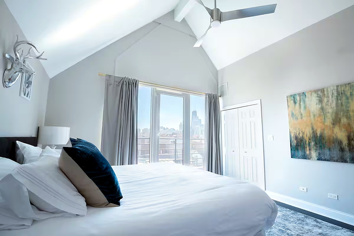 1427 North Mohawk Street Chicago, IL 60610 - Photo 33 of 54 a bedroom with a large bed and a window