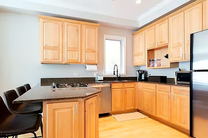 1427 North Mohawk Street Chicago, IL 60610 - Photo 45 of 54 a kitchen with stainless steel appliances granite countertop a stove a sink a microwave and a refrigerator