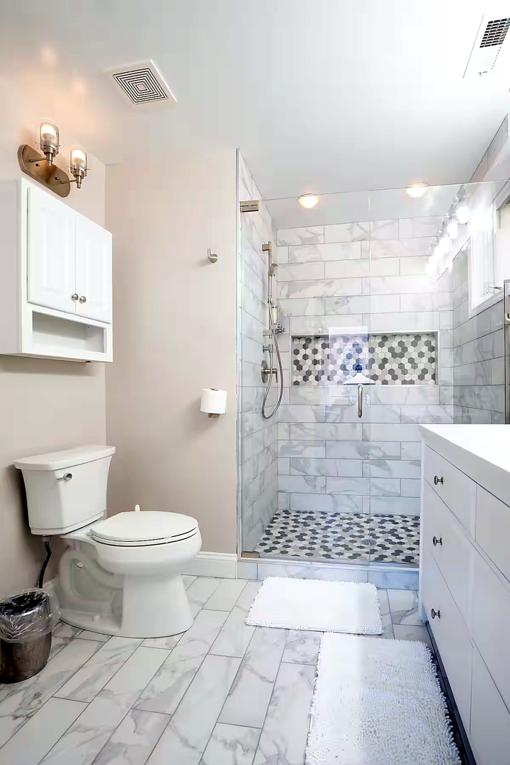 1427 North Mohawk Street Chicago, IL 60610 - Photo 50 of 54 a bathroom with a toilet a sink and shower