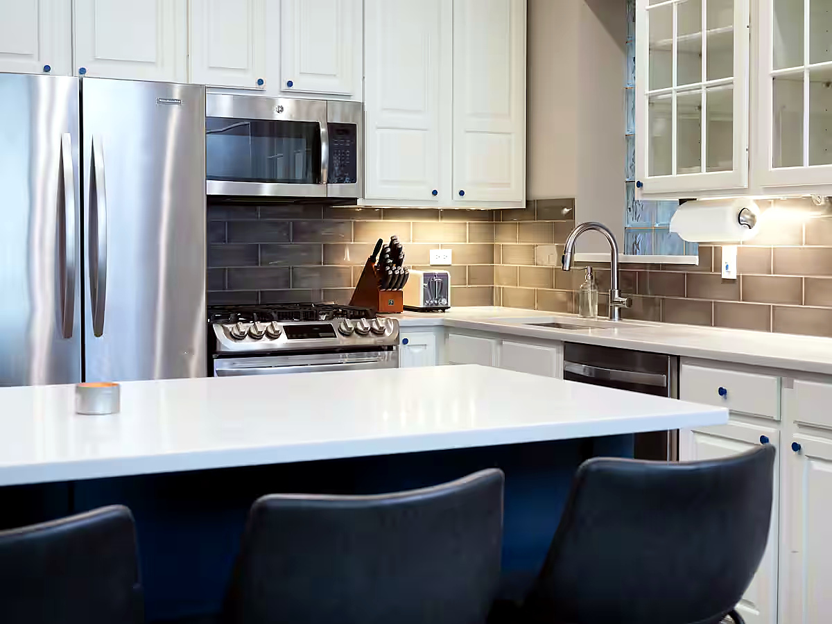 1427 North Mohawk Street Chicago, IL 60610 - Photo 5 of 54 a kitchen with stainless steel appliances a table chairs sink and cabinets