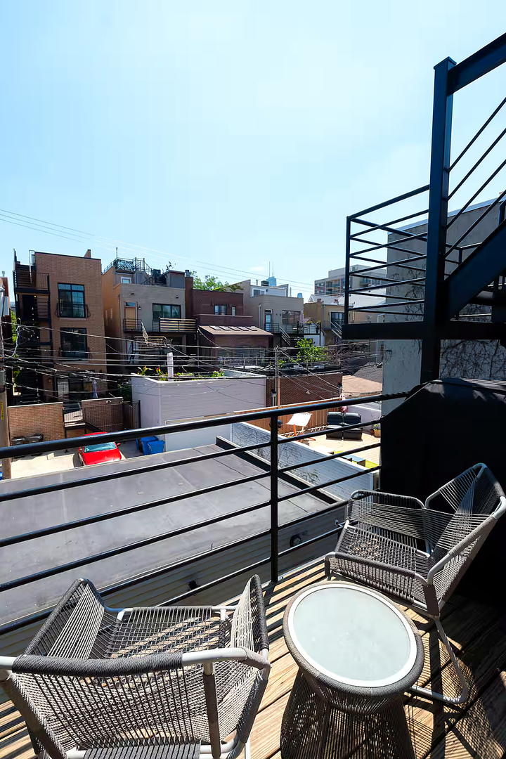 1427 North Mohawk Street Chicago, IL 60610 - Photo 53 of 54 a view of a balcony with table and chairs and a barbeque