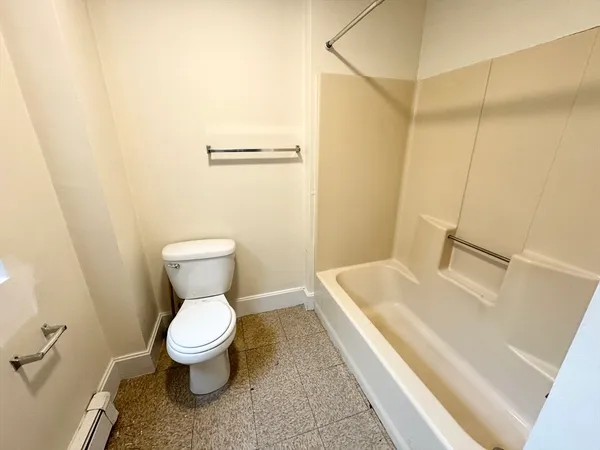 a white toilet sitting next to a bathroom sink