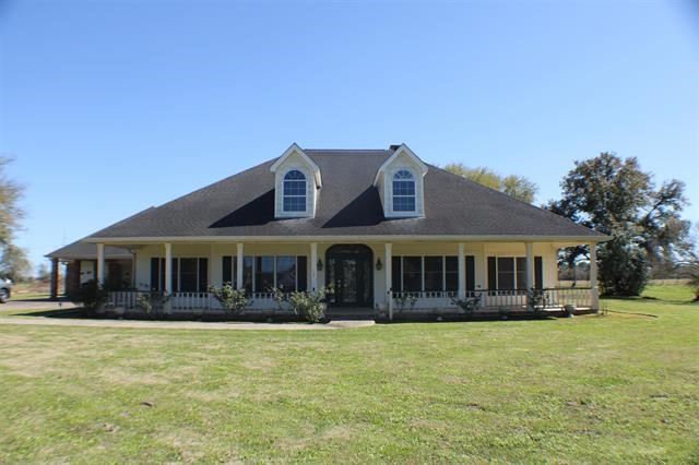 a front view of a house with a yard table and chairs