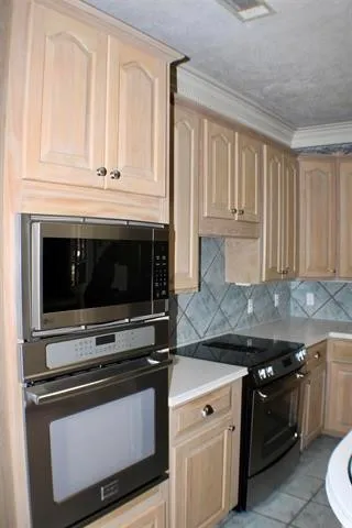 a bathroom with a granite countertop sink a mirror and a shower