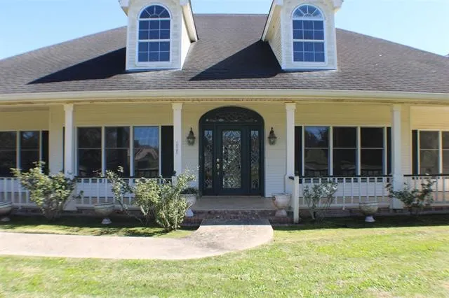 a front view of a house with swimming pool and glass door