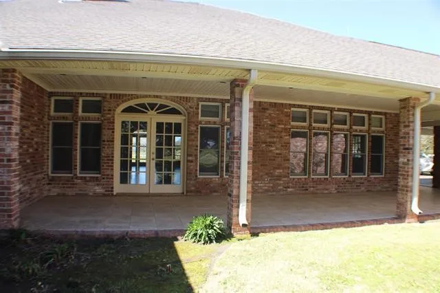 a view of yard with swimming pool and green space