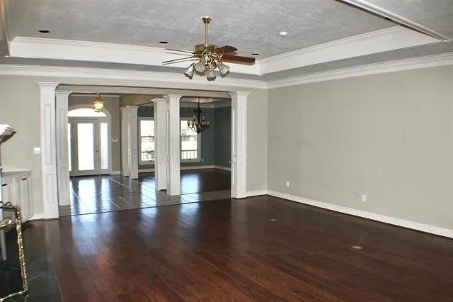 a white kitchen with a sink a stove a refrigerator and cabinets