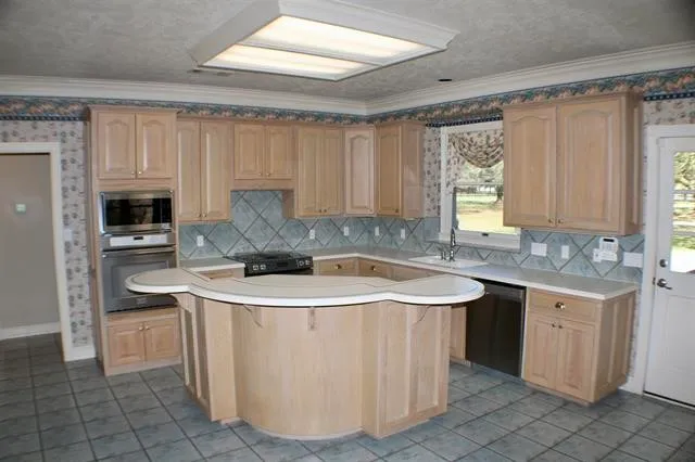 a kitchen with a sink cabinets and window