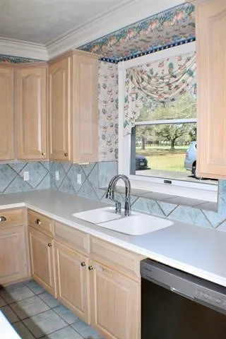 a stove top oven sitting inside of a kitchen
