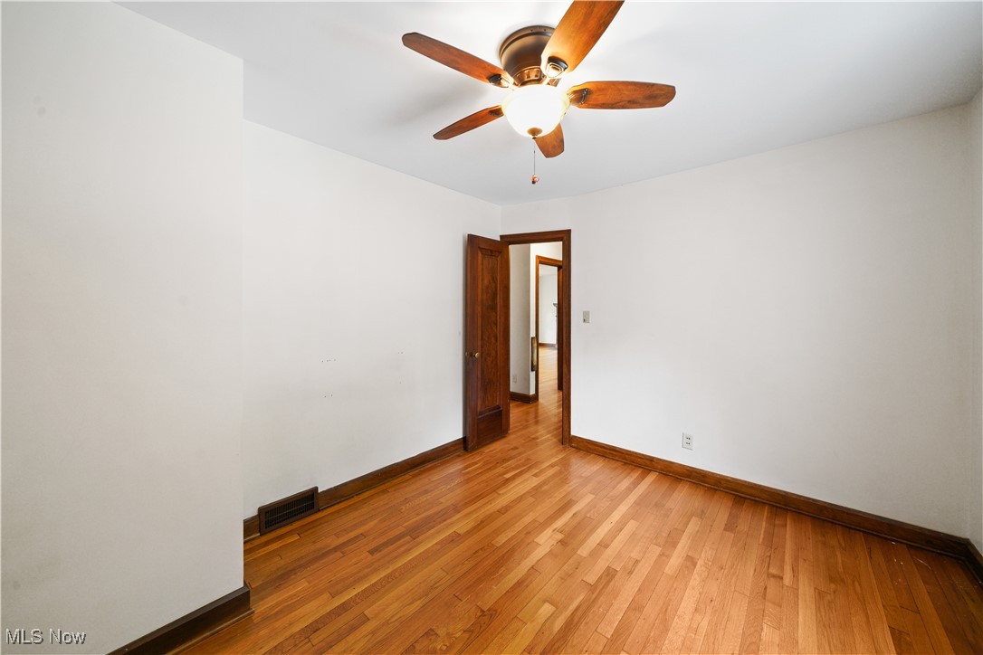 4088 Manchester Road Akron, OH 44319 - Photo 24 of 50 Unfurnished room featuring a ceiling fan, baseboards, and light wood finished floors