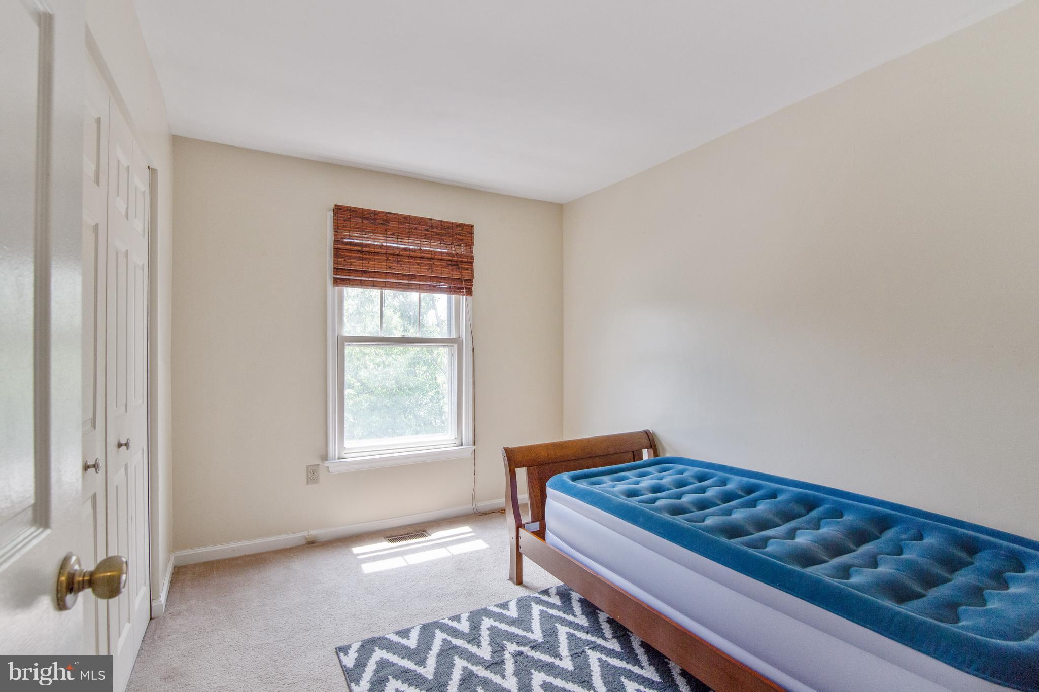 9304 Palmer Place, Unit 5 Laurel, MD 20708 - Photo 29 of 30 a bedroom with a bed and a window