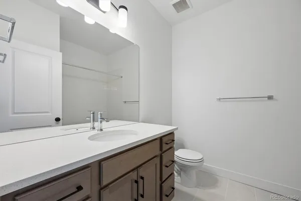 a bathroom with a sink a toilet and mirror