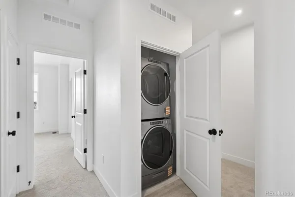 a view of a hallway with washer and dryer
