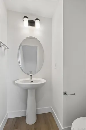 a bathroom with a sink toilet and a mirror