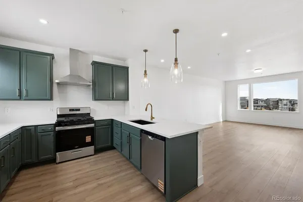 a kitchen with stainless steel appliances granite countertop a stove and a sink
