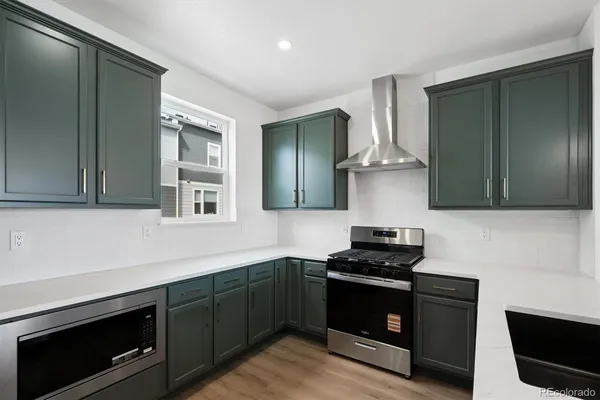 a kitchen with granite countertop a stove and a sink